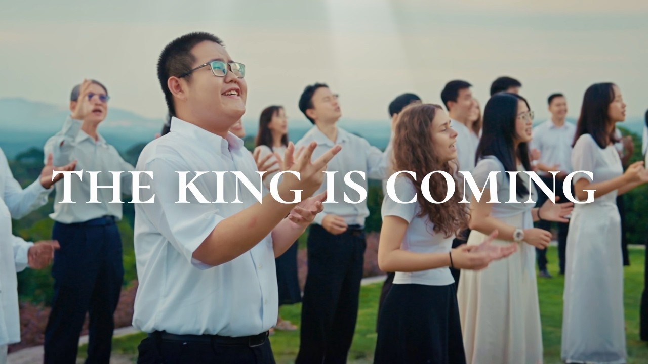 Thumbnail for the music video &ldquo;Jesus Is Coming Again | A Choir Medley of Hope & Victory&rdquo; — a choir in white singing outdoors beneath a shaft of light and the words &lsquo;The King Is Coming&rsquo;