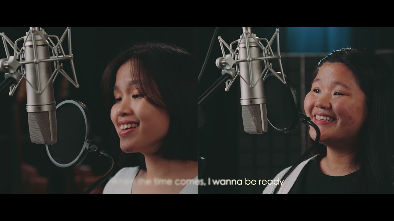 Thumbnail for the music video &ldquo;WHEN THE TIME COMES (Heritage Singers)&rdquo; — Abigail Liong and Alyssa Haijon singing at studio microphones
