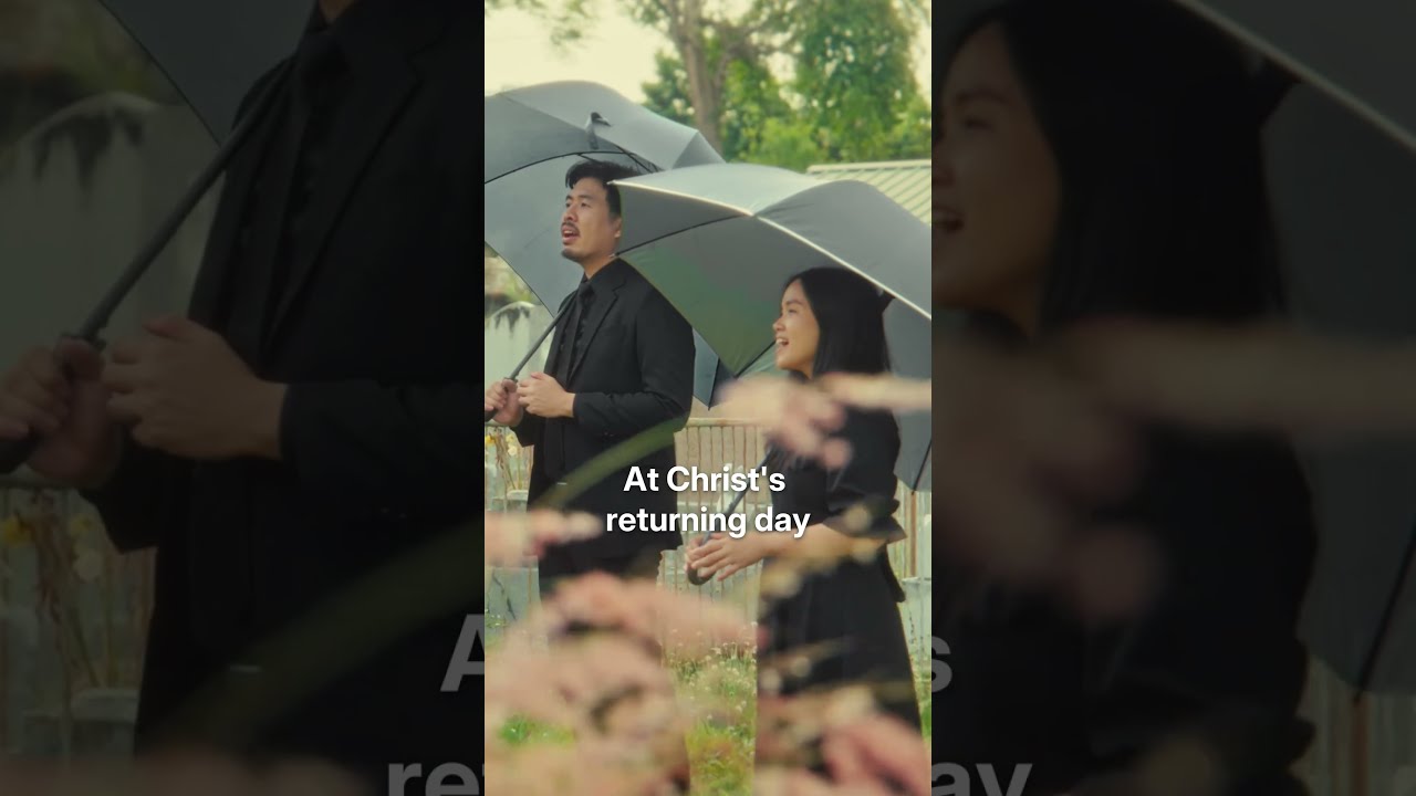 Thumbnail for the Short &ldquo;From Grief to Hope | Until The Morning Dawns (Official MV Teaser)&rdquo; — two singers holding umbrellas among the graves, singing