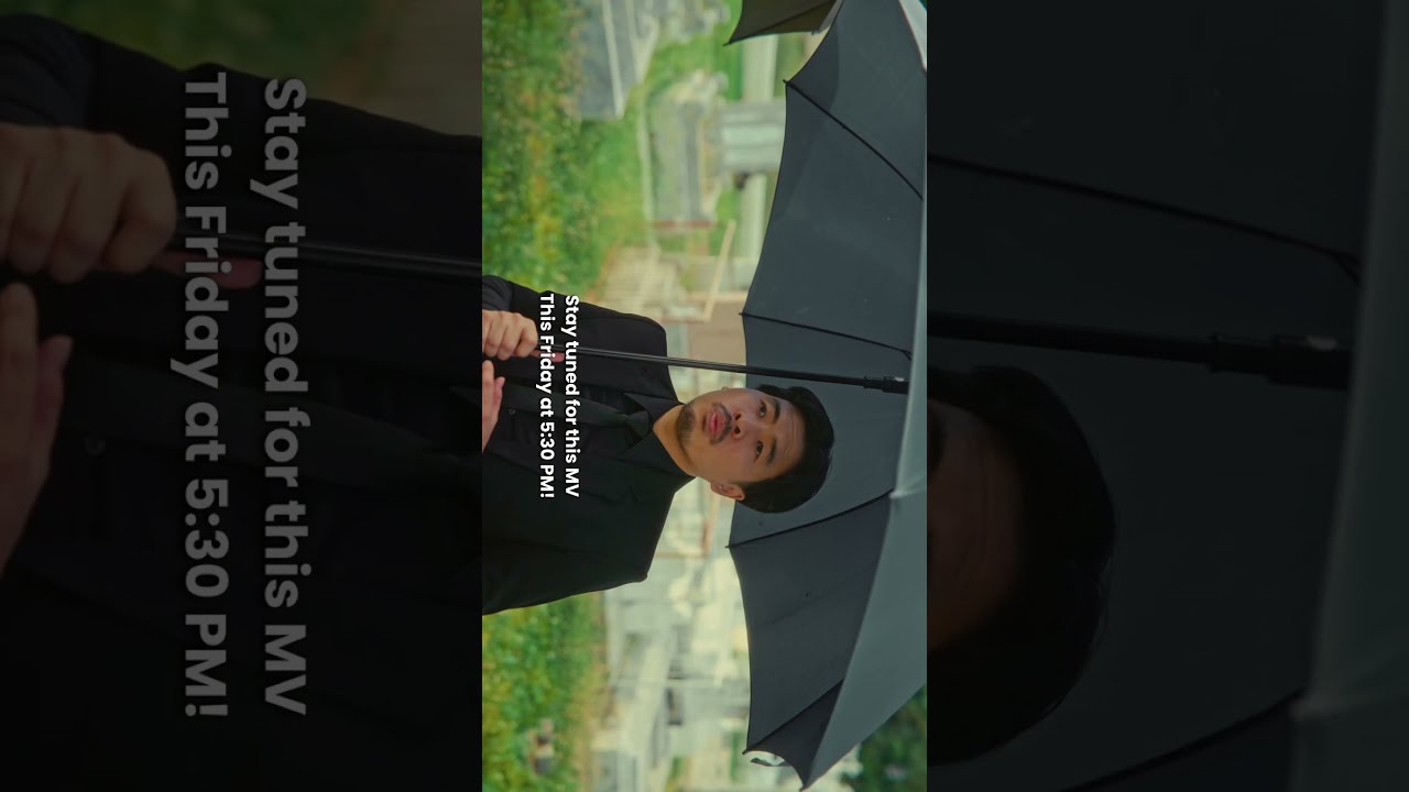 Thumbnail for the Short &ldquo;Death Is NOT The End! | Until The Morning Dawns (BTS Teaser)&rdquo; — a man in a black suit holding an umbrella, behind the scenes at the cemetery