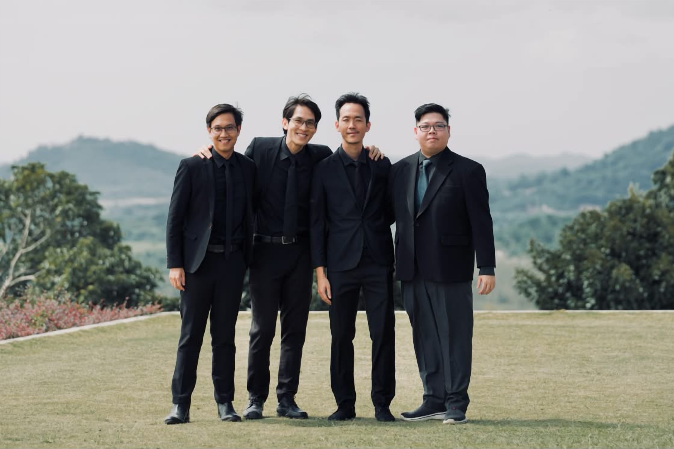The four LoudVoice founders — Russell, Linus, Ian and Alvin — standing together outdoors