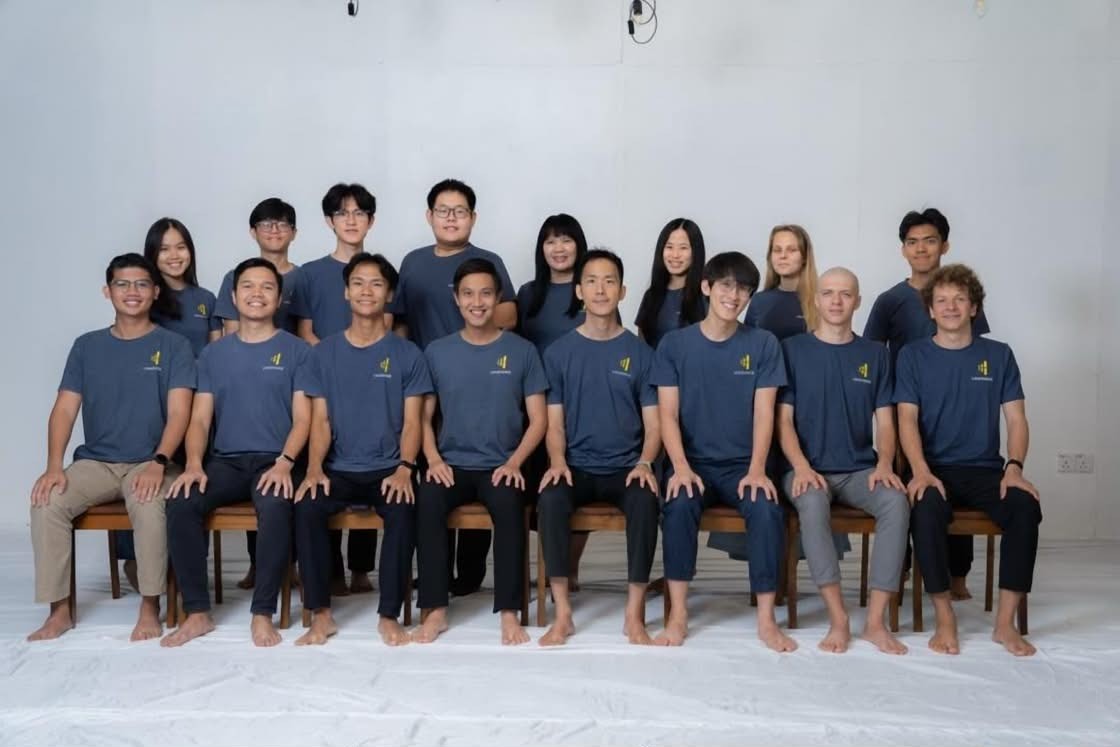 Volunteers and team in navy LoudVoice shirts posing for a formal group photo
